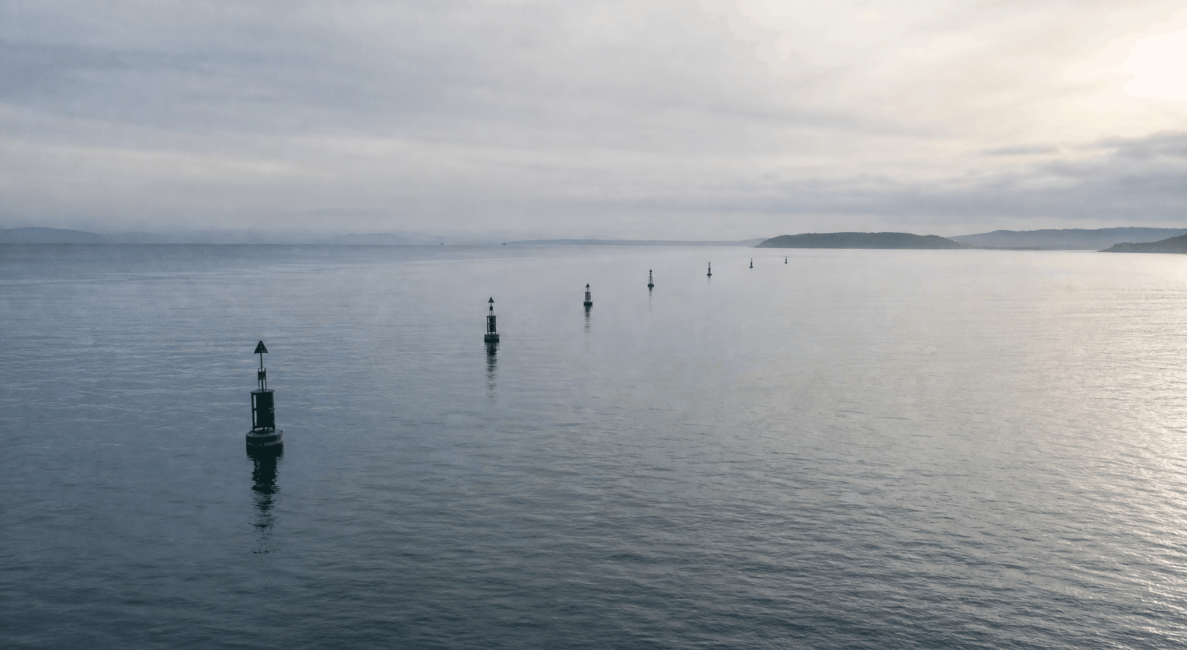 Navigation channel markers in calm open water, suggesting a concise marked route