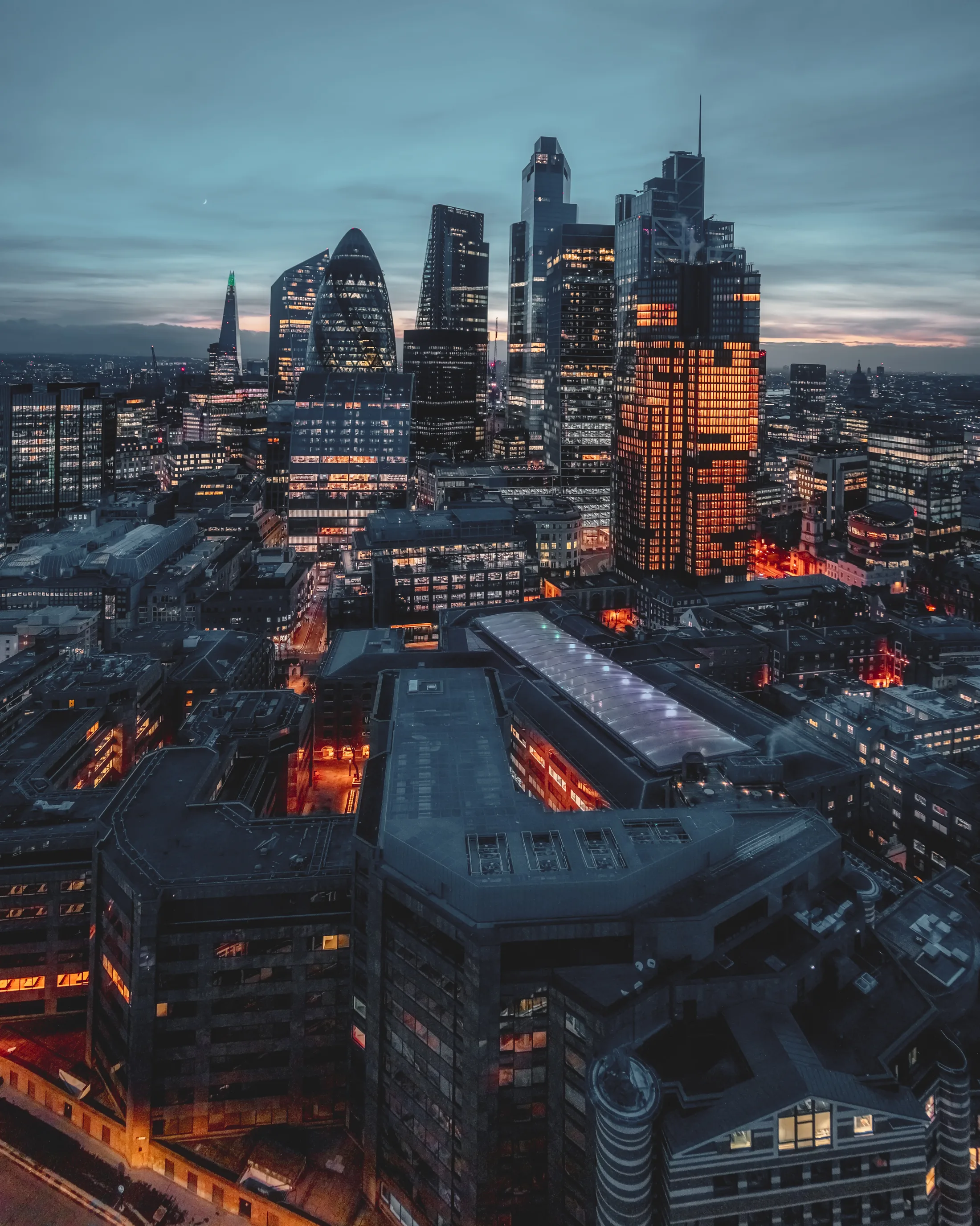 City skyline at dusk under muted cloud